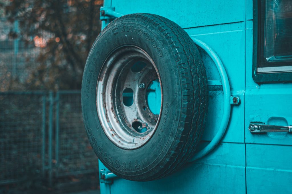 spare tire near a car door